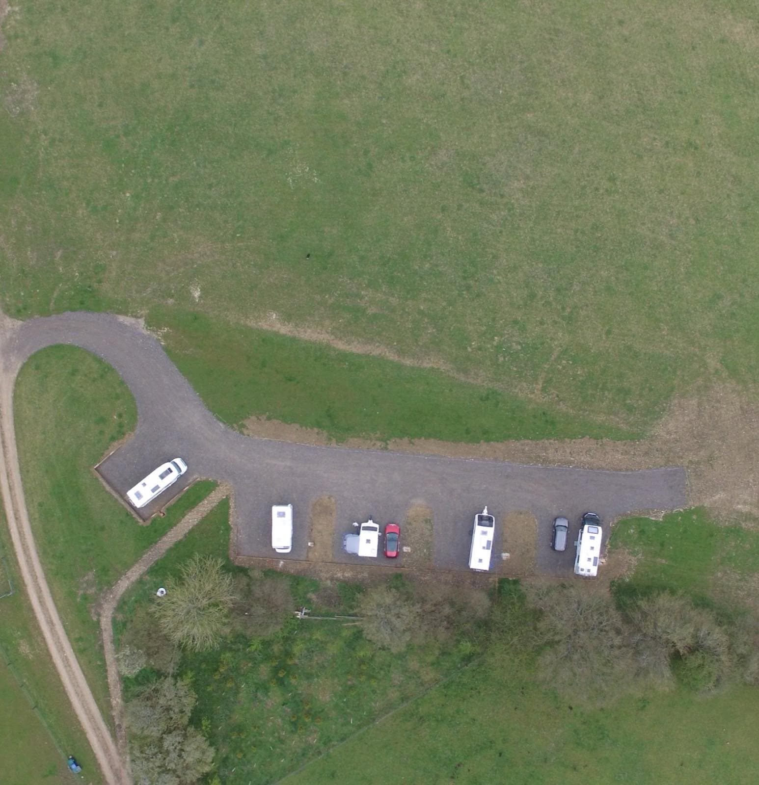 Overhead view of the five hardstanding pitches at Cholsey Grange, laid out along the edge of a field.